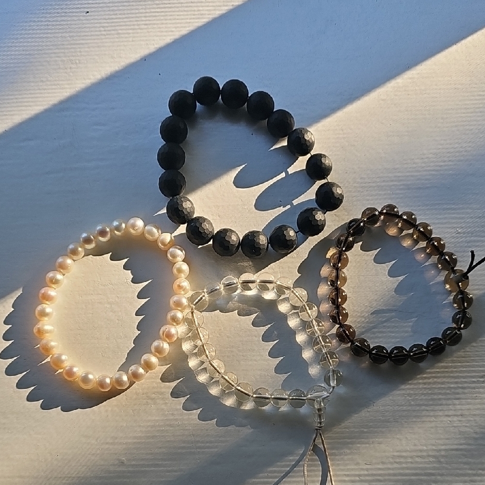 Set of Four Beaded Bracelets in Black, Cream, and Brown